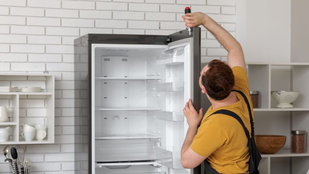 Technician repairing a refrigerator door gasket for appliance repair in Columbia MD