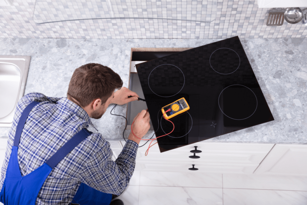 Appliance Repair Expert Fixing Cooktop