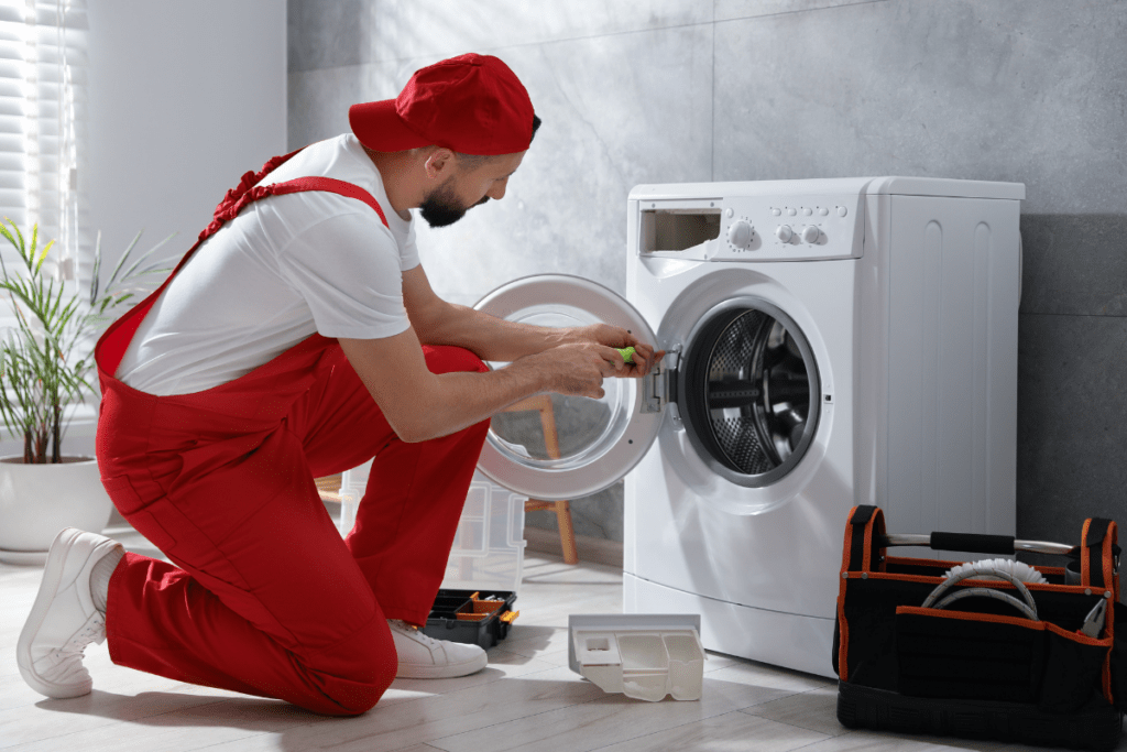 Technician repairing a washer door