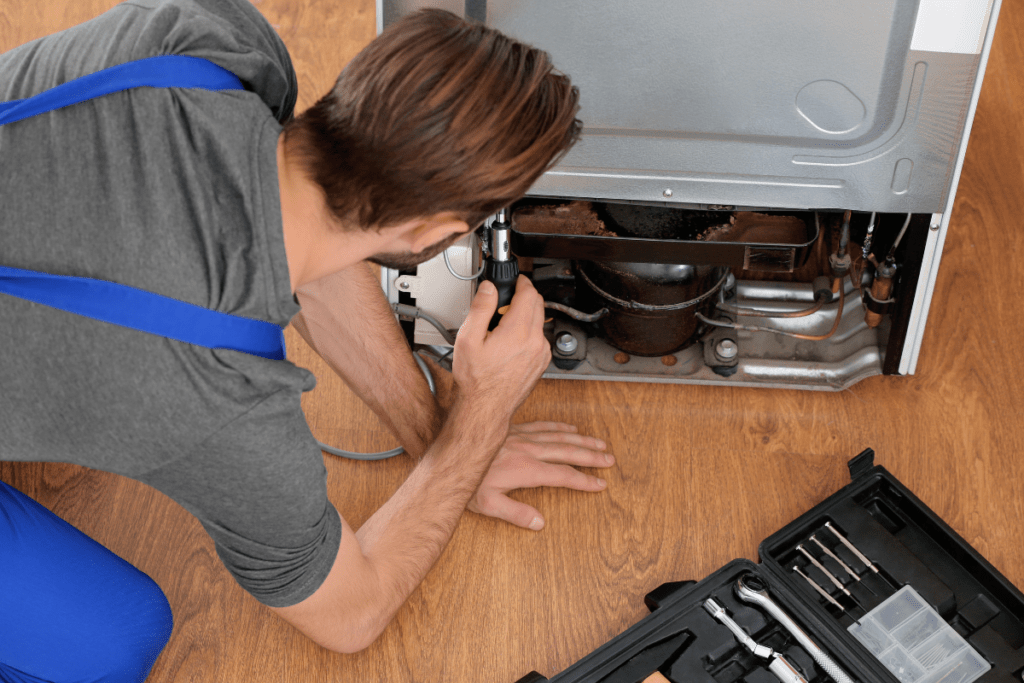 Technician Fixing Refrigerator for Appliance Repair in Kensington MD