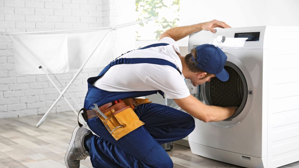 Technician inspecting a washer for appliance repair in Derwood MD