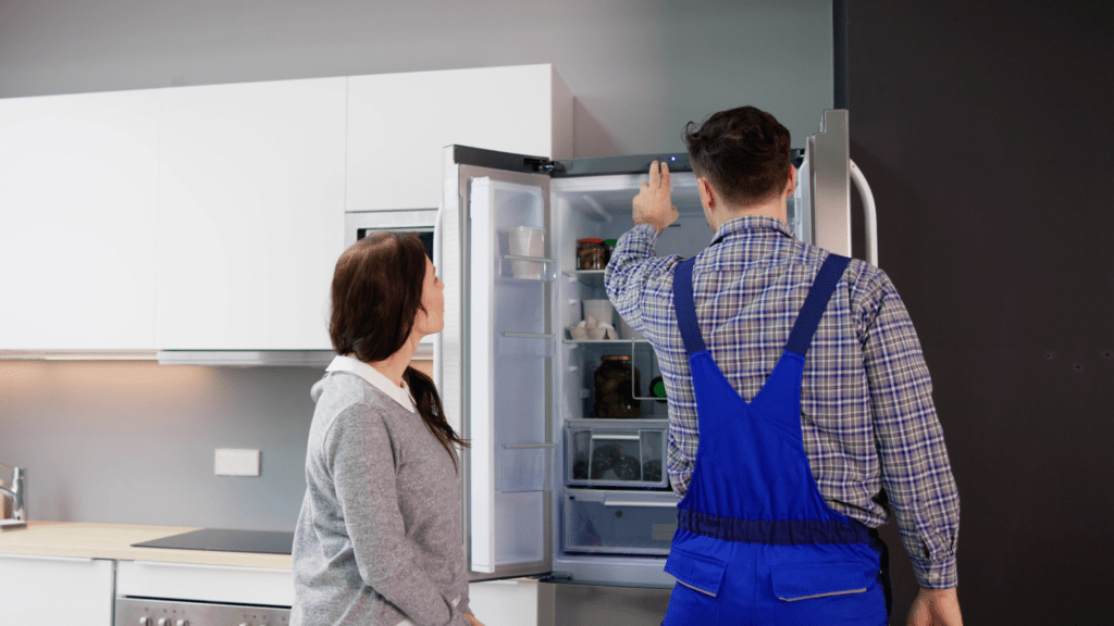 Technician explaining a refrigerator diagnosis to a homeowner for appliance repair in Olney MD