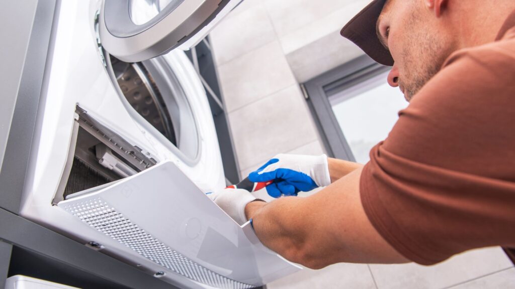 Technician repairing a broken washer for appliance repair in Elkridge MD