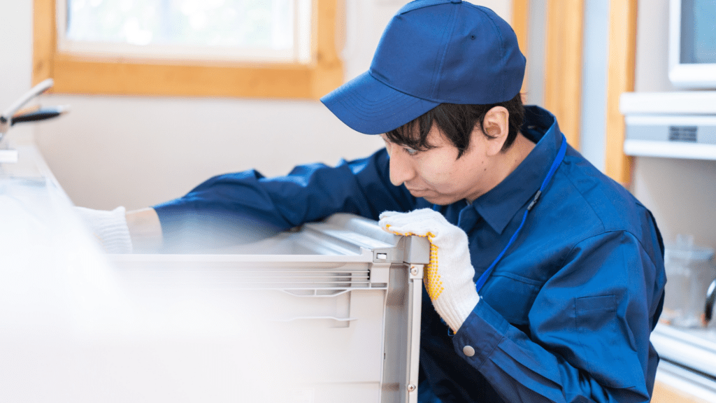 Technician inspecting a refrigerator for appliance repair in Oakton VA