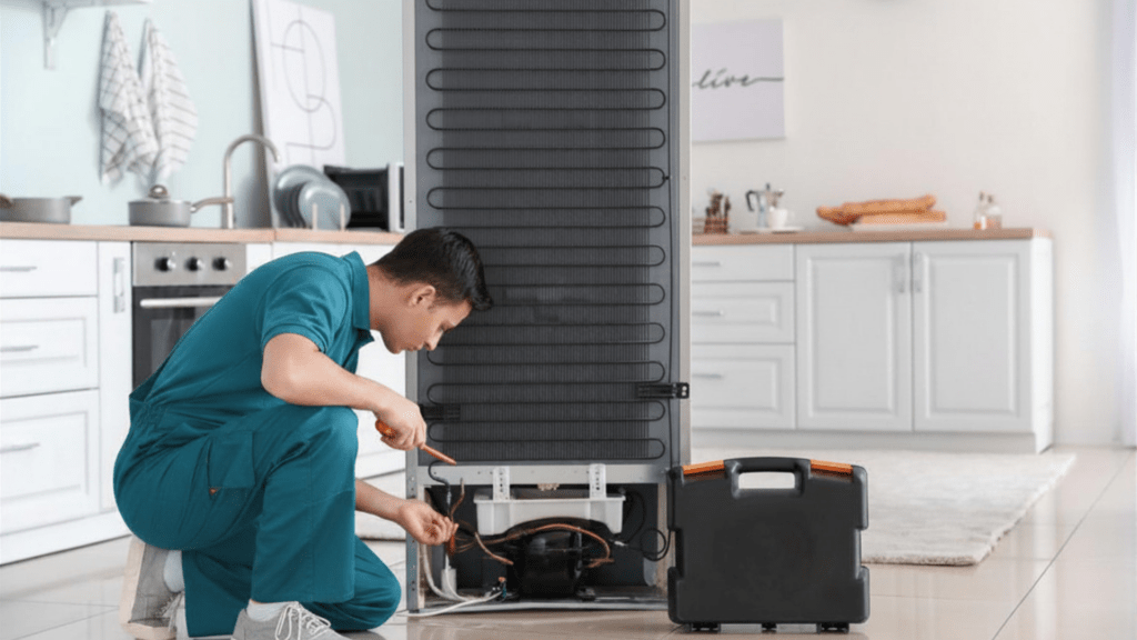 Technician diagnosing a refrigerator problem for appliance repair in Oxon Hill MD