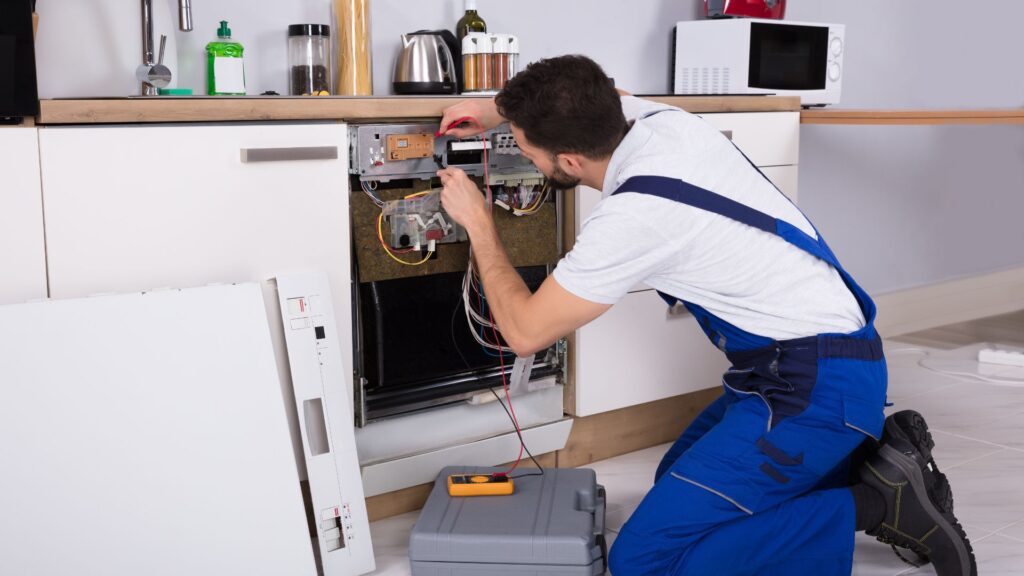 Technician examining a dishwasher for appliance repair in Dupont Circle DC