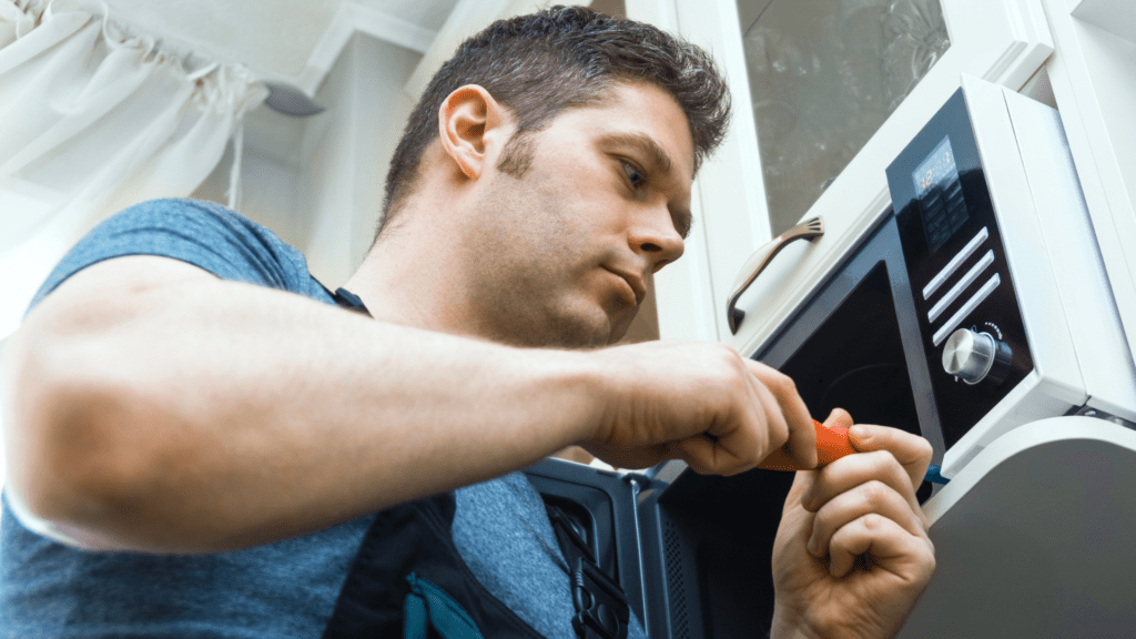 Technician repairing a microwave for appliance repair in Mitchellville MD