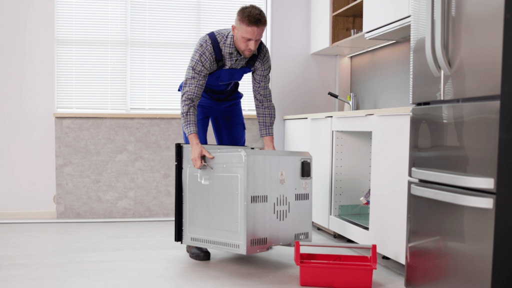 Technician installing an oven for appliance repair in Greenbelt MD
