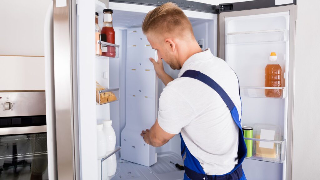 Technician repairing a refrigerator for appliance repair in Franconia VA