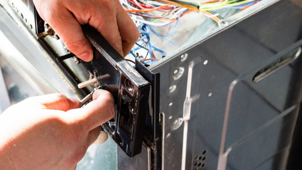 Technician repairing an electric stove for appliance repair in District Heights MD