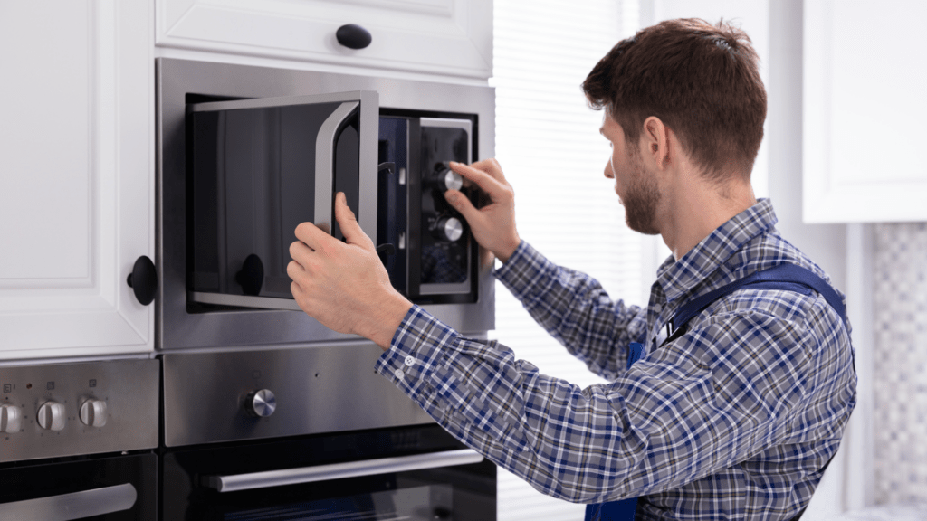 Technician inspecting microwave oven controls for appliance repair in Jefferson MD