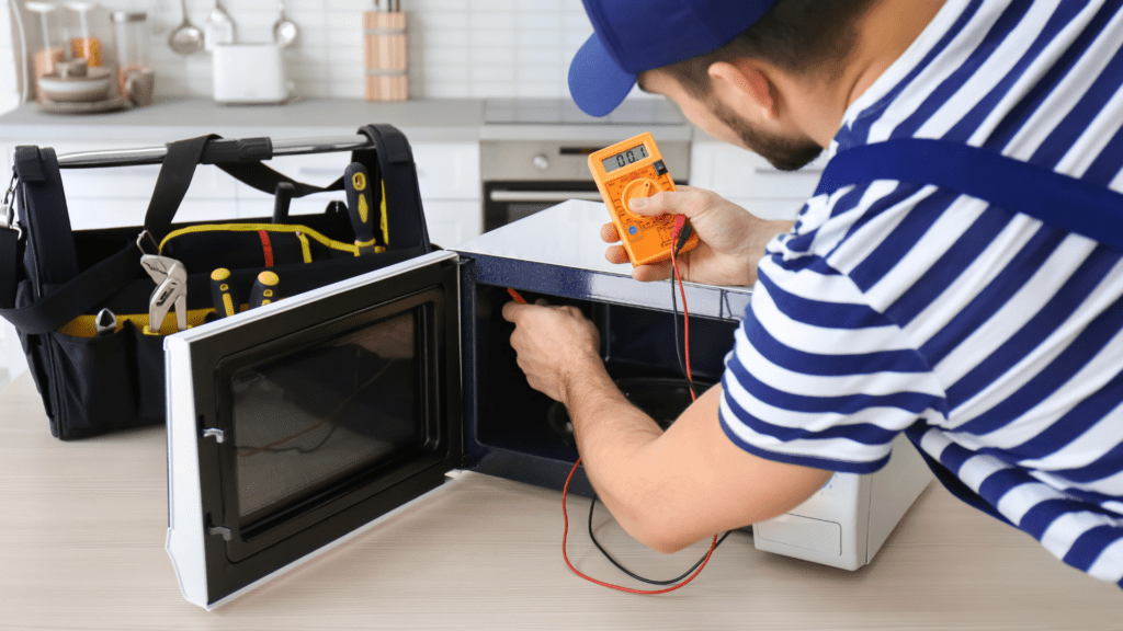Technician inspecting a microwave for appliance repair in Lincolnia VA