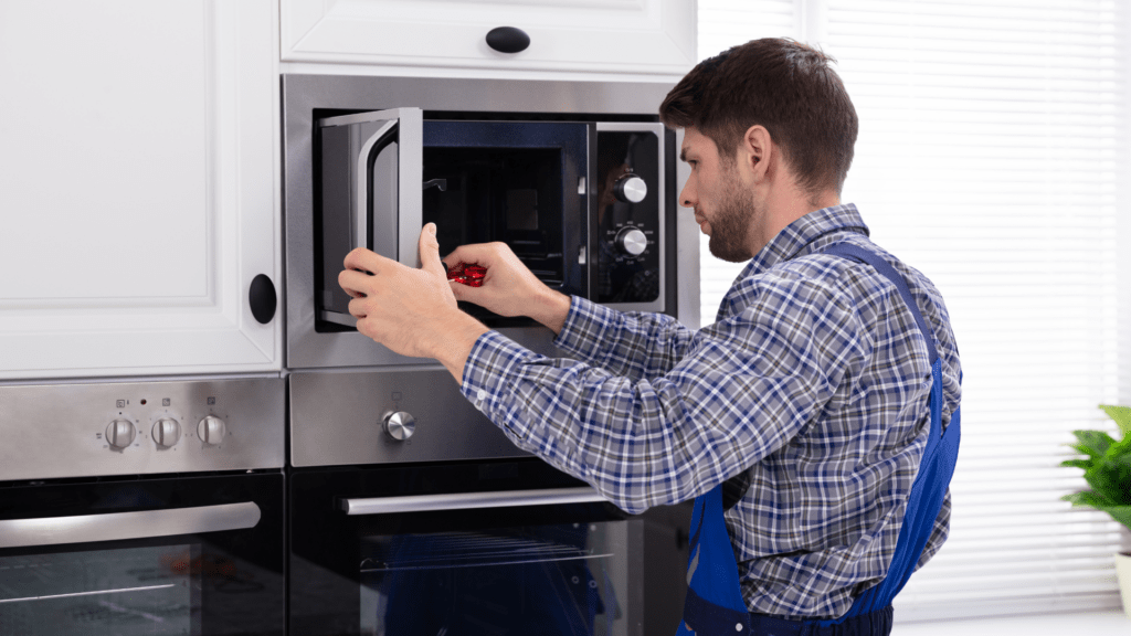 Technician diagnosing a built-in microwave for appliance repair in Linganore MD