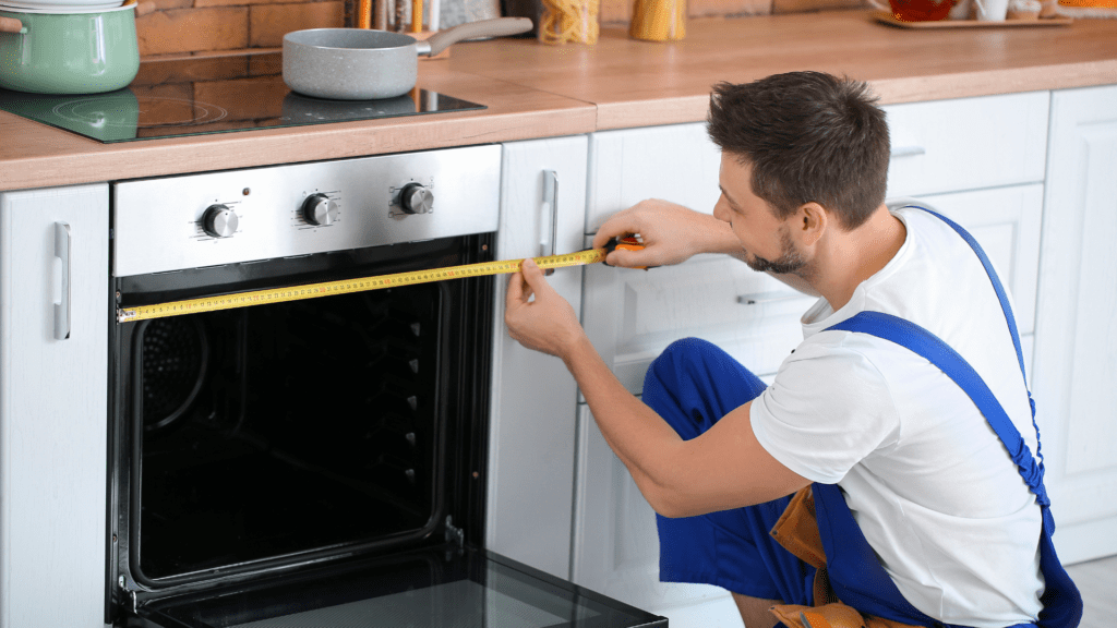 Technician repairing an oven in a kitchen for appliance repair in Fulton MD