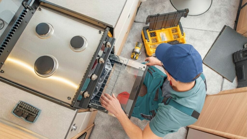 Technician replacing a broken gas stove for appliance repair in Fairland MD