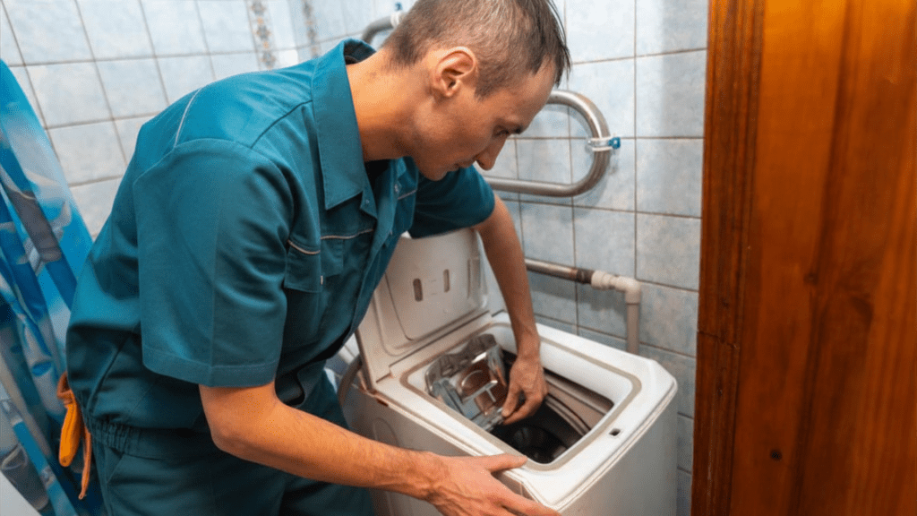 Technician repairing a washing machine for appliance repair in McLean VA