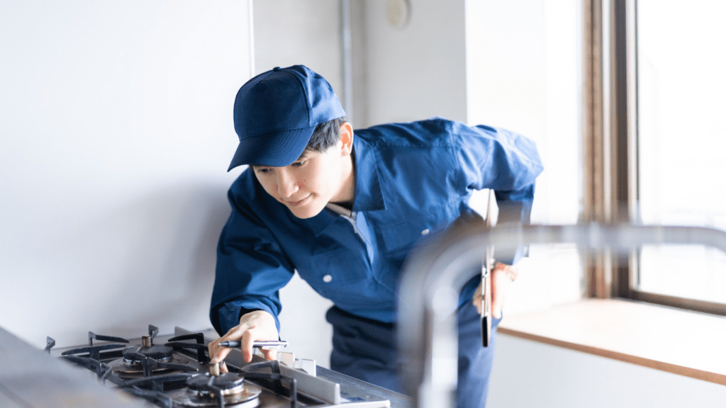 Technician diagnosing a gas stove for appliance repair in Urbana MD