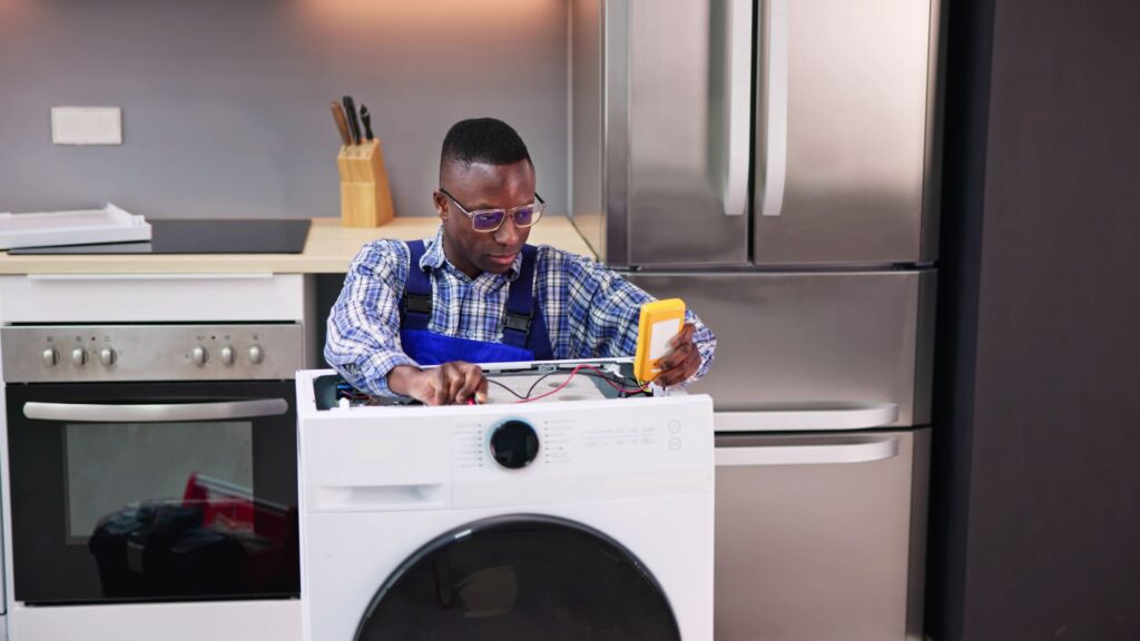 Technician inspecting a washer for appliance repair in Chantilly VA