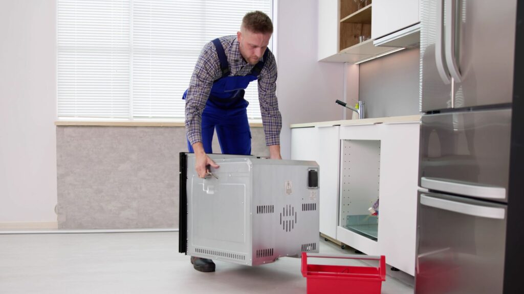 Technician installing a new dishwasher for appliance repair in Cascades VA