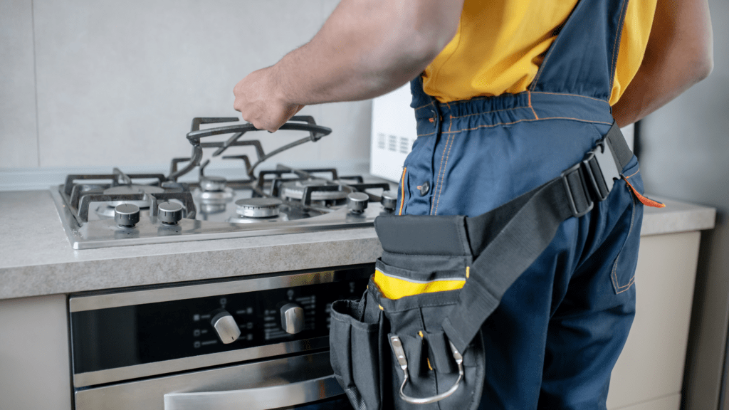 Technician repairing a gas stove for appliance repair in Tysons VA