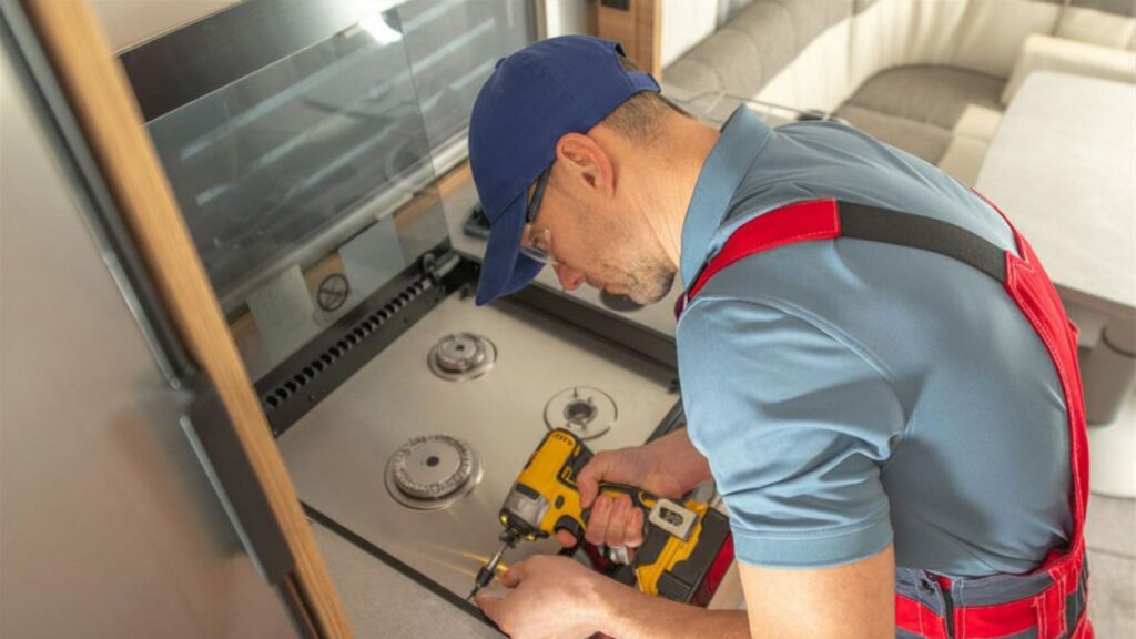 Technician repairing a cooktop for appliance repair in Centreville VA