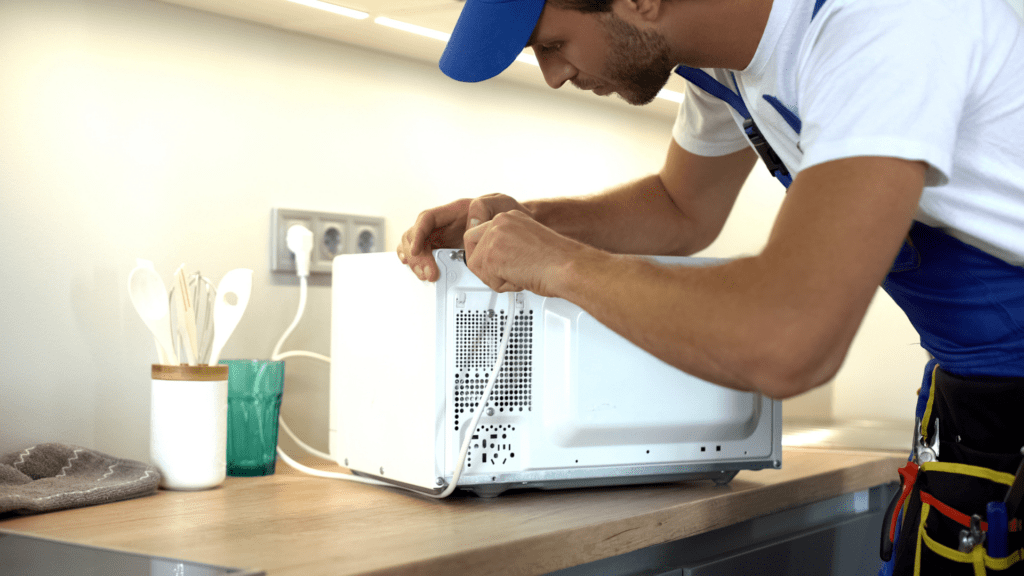 Technician repairing a microwave for appliance repair in Vienna VA