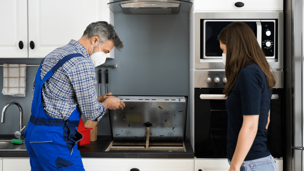 technician diagnosing the electric cooktop for appliance repair in Adams Morgan dc