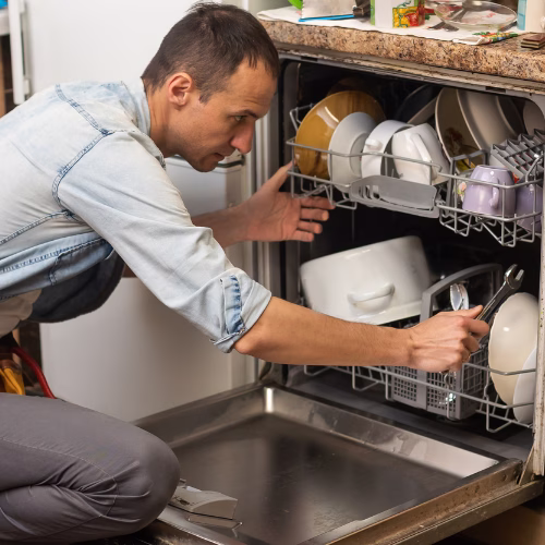 Technician repairing a dishwasher for appliance repair in Cloverly MD