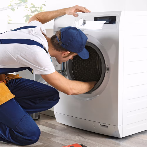 Technician inspecting a washer for appliance repair in Derwood MD