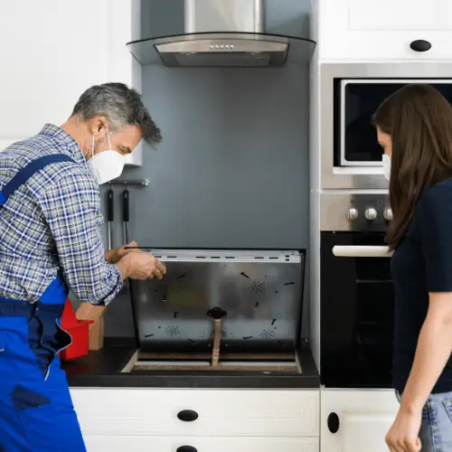 Technician diagnosing the electric cooktop for appliance repair in adams morgan dc