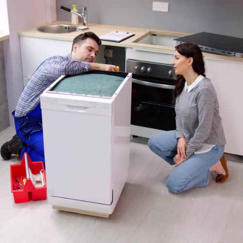 Professional technician diagnosing a dishwasher for appliance repair in Falls Church VA
