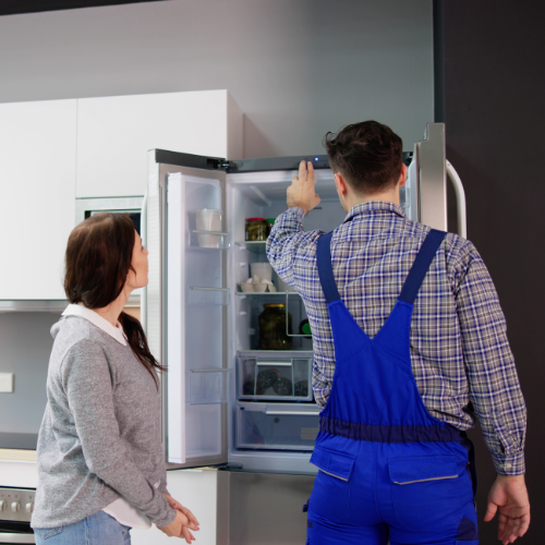 Technician explaining a refrigerator diagnosis to a homeowner for appliance repair in Olney MD
