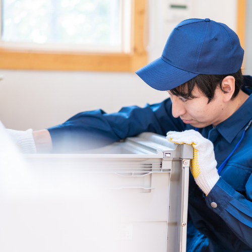 Technician inspecting a refrigerator for appliance repair in Oakton VA