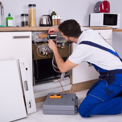 Male Technician Examining Dishwasher for Appliance Repair in Dupont Circle DC