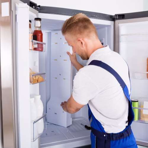 Technician repairing a refrigerator for appliance repair in Franconia VA