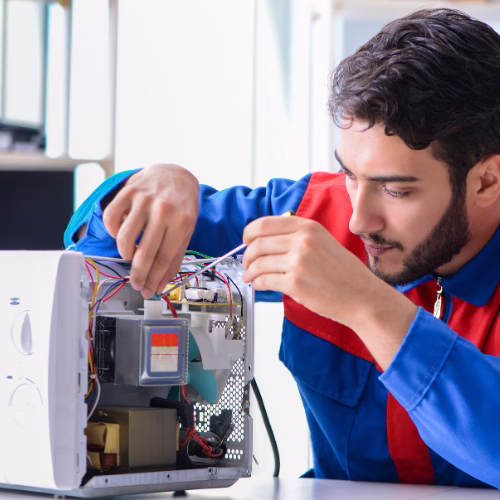 Technician repairing a microwave oven for appliance repair in Fort Washington MD