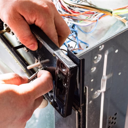 Repairman Repairing Electric Stove for Appliance Repair in District Heights
