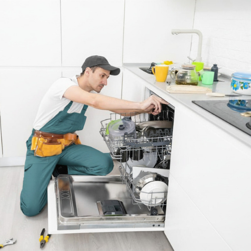 Technician inspecting a dishwasher door for appliance repair in North Laurel MD