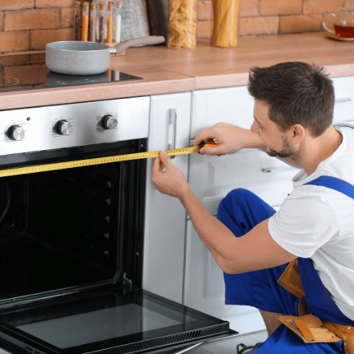 Technician repairing an oven in a kitchen for appliance repair in Fulton MD