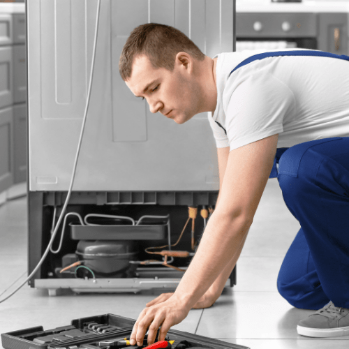 Technician Repairing Refrigerator in Kitchen for Appliance Repair in Landover MD