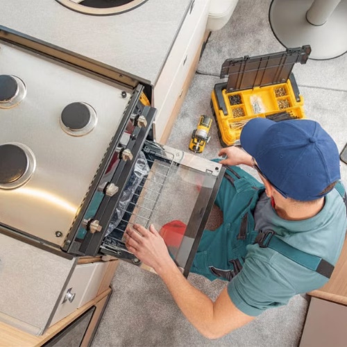 Technician replacing a broken gas stove for appliance repair in Fairland MD