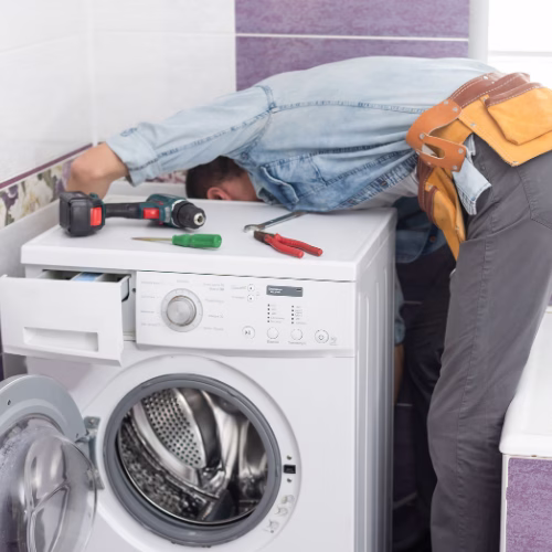 Technician repairing a dryer for appliance repair in Chevy Chase Village MD