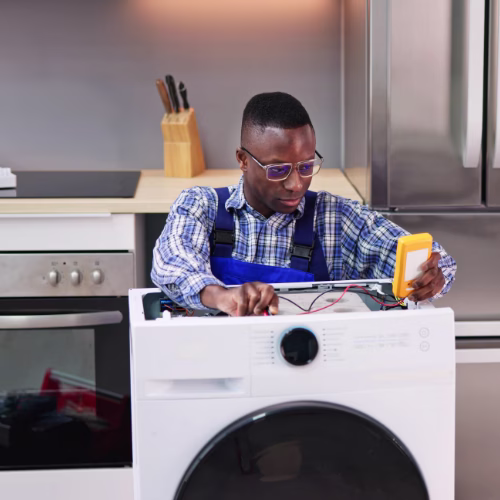 Technician inspecting a washer for appliance repair in Chantilly VA