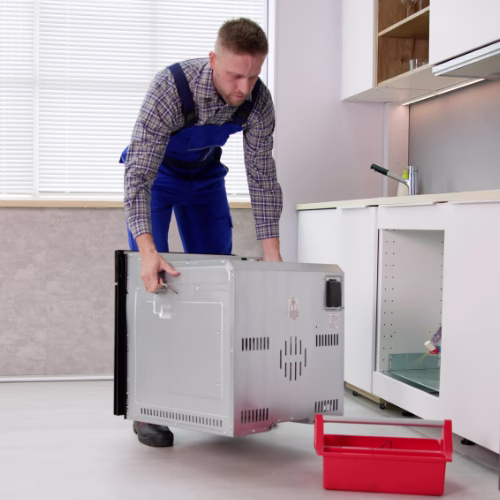 Technician installing a new dishwasher for appliance repair in Cascades VA