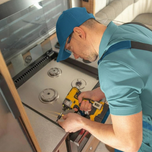 Technician installing stove parts for appliance repair in Upper Marlboro MD