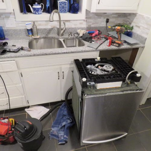 Technician repairing a kitchen dishwasher for appliance repair in Broadlands VA