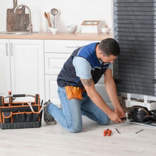 Technician Repairing Refrigerator for Appliance Repair in Springfield VA