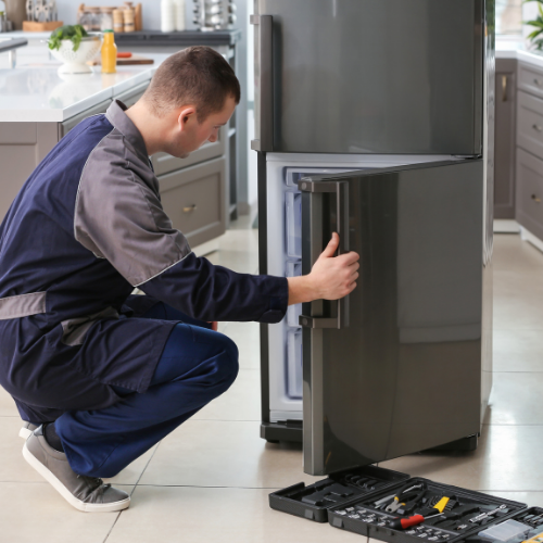 Technician diagnosing a refrigerator problem for appliance repair in Purcellville VA