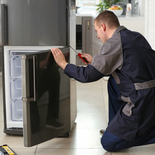 technician-checking-the-refrigerator-door-hinge-for-appliance-repair-in-College-Park-MD