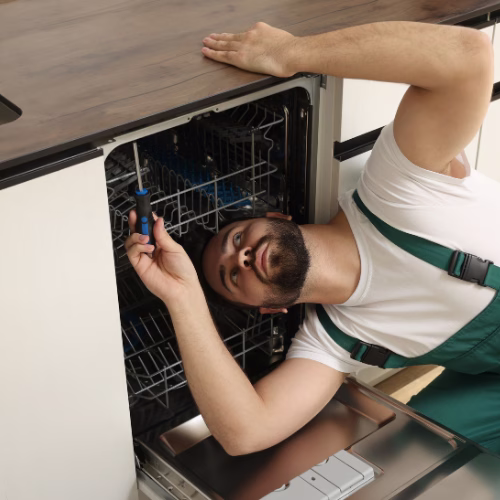 Technician diagnosing a dishwasher during appliance repair in Burtonsville MD, providing reliable dishwasher repair service for homeowners in Montgomery County